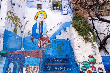 Chefchaouen, Morocco -march 26, 2024:drawings on blue walls of Chefchaouen in Morocco during a cloudy day