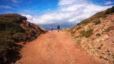 Hiking through the Somiedo natural park in Asturias, alongside its lakes, Spain clipart