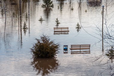 Uralsk, Oral, Kazakhstan (Qazaqstan), 13.04.2024 - The embankment was flooded in Uralsk. Flooded benches on the embankment in the city of Uralsk. Flood in Kazakhstan. clipart