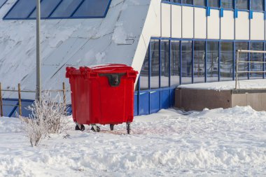 A red garbage container. Plastic container for waste collection. Euro container for waste clipart