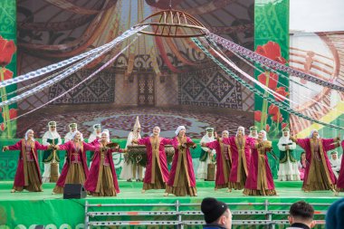 Uralsk, Kazakistan (Kazakistan), 22.03.2025: Nauryz tatilinin büyük sahnesinde ulusal kostümlerle dans etmek. Nauryz tatili.