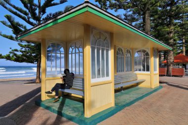 UNRECOGNIZABLE INCIDENTAL PEOPLE IN THE IMAGE. The Shelter Shed at South Steyne in Manly suburb unveiled in 16 March 1940 is an icon for local and tourist beachgoers placed next to the entrance stairs to the beach. Sydney-New South Wales-Australia