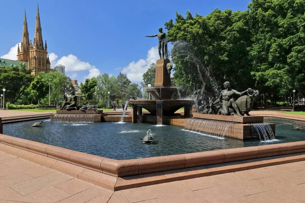 stock image J.F.Archibald Memorial Fountain in Hyde Park by Francois-Leon Sicard placed in 1932 depicting Apollo on top, Diana on left, Pan on right. St.Mary's Cathedral in left background. Sydney-NSW-Australia.