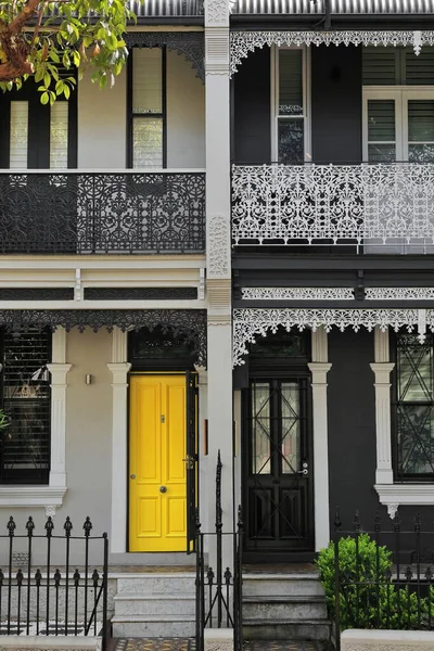 stock image Facades of terrace houses in Victorian Filigree style featuring prominent party wall and verandahs decorated with laced cast iron screens on Liverpool Street, Paddington suburb. Sydney-NSW-Australia.