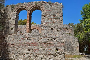 Güney koridorunun dış duvarında tuğladan yapılmış yuvarlak kemerler, MS 5. yüzyıl sonuyla MS 6. yüzyıl başları arasında inşa edilmiş büyük bazilika, Butrint arkeolojik alanı. Vlore ilçesi-Arnavutluk.