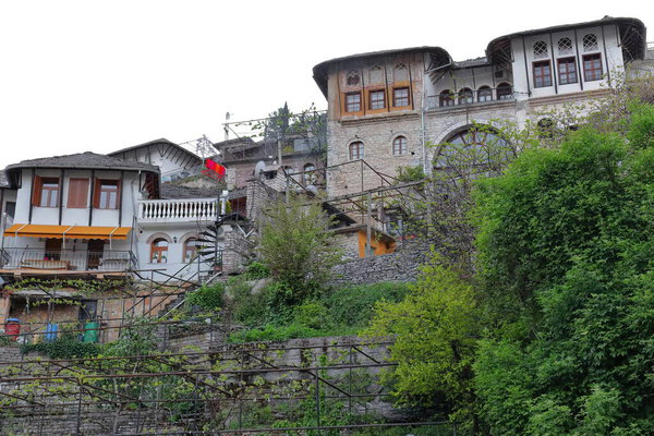 Ottoman style tall houses dating from the XVII-XVIII centuries built with stone blocks and featuring roofs covered with flat dressed stones on the slope surrounding the citadel. Gjirokaster-Albania.