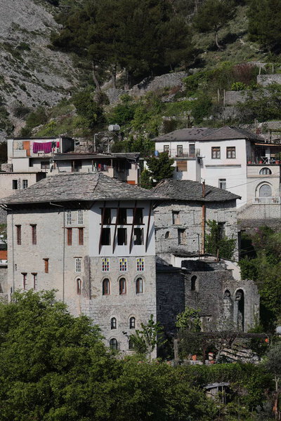 Hillside Ottoman houses dating from the XVII-XVIII centuries built with stone blocks and featuring roof covers of flat dressed stones, southwestwards view from the city fortress. Gjirokaster-Albania.