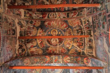 Permet, Albania-April 17, 2019: Saint Mary's Church of Leusa dates from the 18th century, built on older Byzantine-era remains. Wall paintings from 1812 depicting Bible scenes, Virgin Mary Theotokos. clipart
