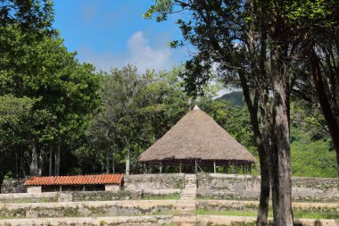 Las Terrazas, Cuba-October 9, 2019: The tajona of the AD 1801 built Cafetal Buenavista Coffee Estate hosts the stone mill used to extract the seeds -beans- from the flesh -shell- of the coffee cherry. clipart