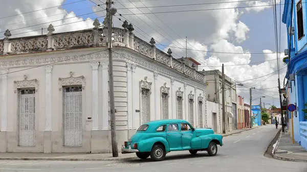 stock image Bayamo, Cuba-October 16, 2019: Mint green American classic car -Chevrolet Stylemaster 4 door Sedan from 1947- turns the corner of Calles Jose A.Saco and C.M.Cespedes streets and drives southeastward.