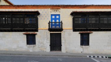 Santiago, Cuba-October 20, 2019: The 1515 built Diego Velazquez House, country's oldest, at the Calles Francisco Aguilera and Santo Tomas or Felix Pena Streets corner, facade to Parque Cespedes Park. clipart