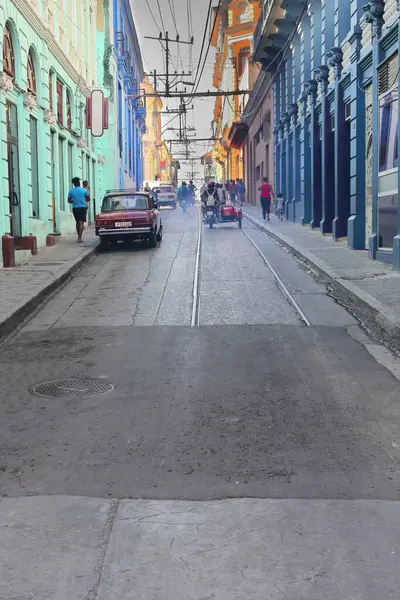 stock image Santiago, Cuba-October 20, 2019: Calle Hartmann Street tract between Calle Enramadas and Heredia Streets suffering from smoky-noisy motorbike and sidecar traffic, featuring out of use old tram tracks.