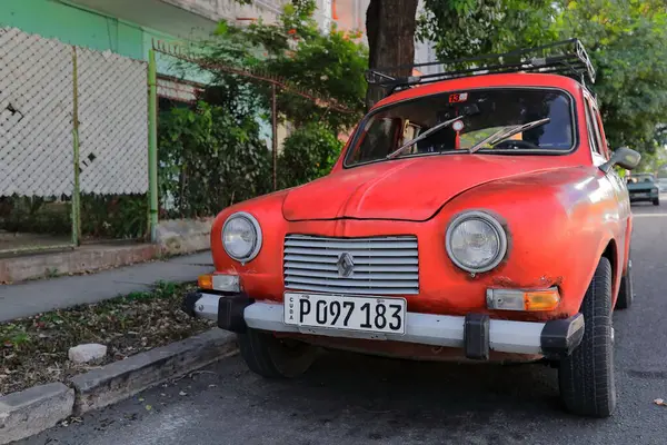 stock image Havana, Cuba-October 25, 2019: Old red European classic car -Renault with a front side mix of Fregate and modified Dauphine models from the 1950s- parked on Calle Calzada Street, Vedado neighbourhood.