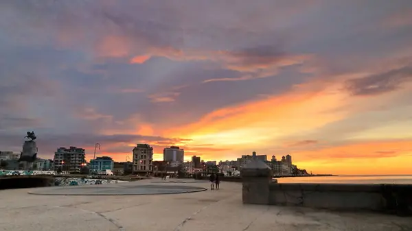 stock image Havana, Cuba-October 26, 2019: Sunset view of the seawall parapet and the buildings in row along the Malecon Esplanade from the Parque Maceo Park area to the Edificio Someillan building. Havana-Cuba.