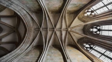 Mont-Saint-Michel, France-October 19, 2020: Detail of ribbed vault on the ceiling of a small chapel jutting out from the ambulatory around the 1450 to 1521 built, Flamboyant-style Abbey-Church choir. clipart