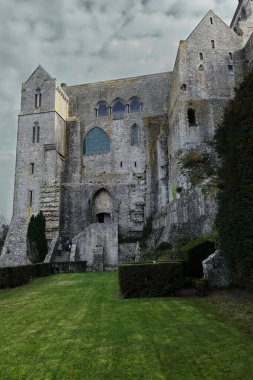 Thick stone walls of La Merveille-The Marvel facing north and west overlooking the garden on the north slope of Mont-Saint-Michel. Normandy-France-140 clipart