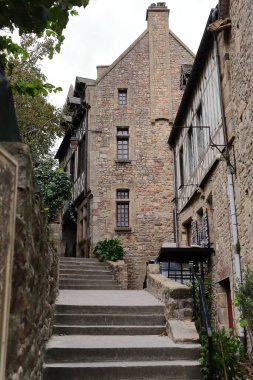 Mont-Saint-Michel, France-October 19, 2020: Row of medieval buildings on the east side of the Grande Rue-Main Street uppermost area leading to the Grand Degre staircase at the entrance to the abbey. clipart