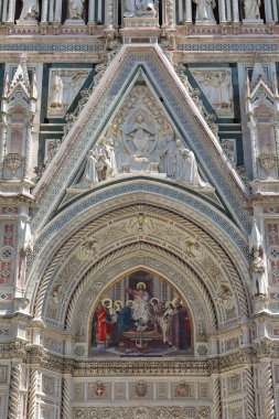 Florence, Italy-May 17, 2022: Lunette above the central portal of the Cattedrale di Santa Maria del Fiore Cathedral, AD 1887-inaugurated neo-Gothic facade in polychrome marble by Emilio de Fabris.