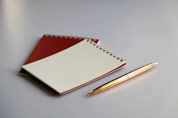 Side view on a pen and notepads. Selective focus
