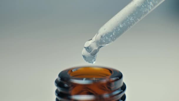 マッサージのための化粧品油とピペットと茶色のボトル クローズアップに流れる滴 — ストック動画