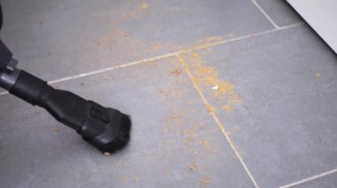 Döşemeleri süpürüp, yerleri süpürüp, evi temizleyip, kanepenin altını süpürüp, zemini yavaş çekimde süpürüyor..