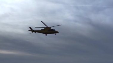 Helikopter açık mavi gökyüzü üzerinde uçuyor. Yavaş çekim.