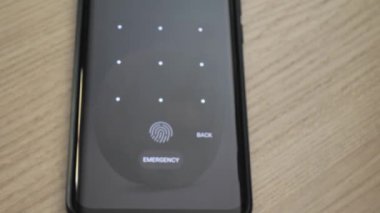 a man enters a graphic PIN code on a smartphone screen to unlock the phone. Control access to data inside the phone. Login is successful. Access is open. 4K