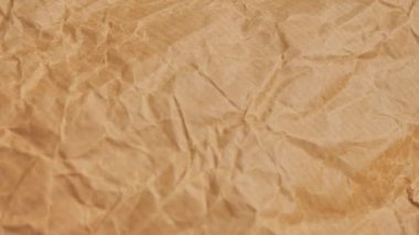 Kahverengi buruşmuş kağıt doku arkaplanının hareketini durdur.