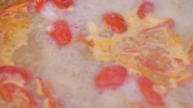 Tomato sauce is boiling in a pan, close-up