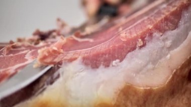 Cut juicy appetizing jamon, close-up. Spanish jamon
