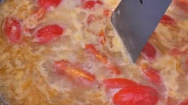 Tomato sauce is boiling in a pan, close-up