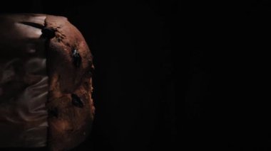 Pandora close-up, a typical Italian pastry, on a black background, vertical video