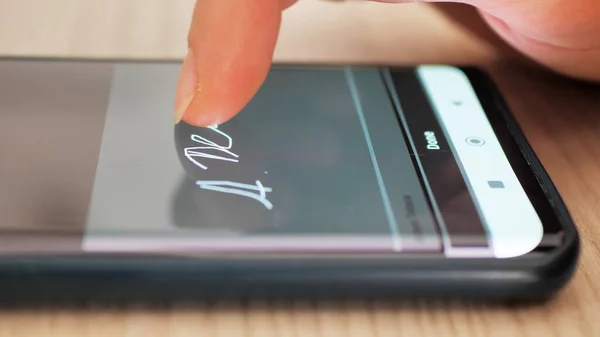 Electonic signature with finger in phone screen.