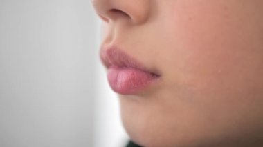 Happy portrait of smiling baby with full plump lips. Grimace, part of the face. A charming teenage boy. Face expression. The concept of beauty, health.