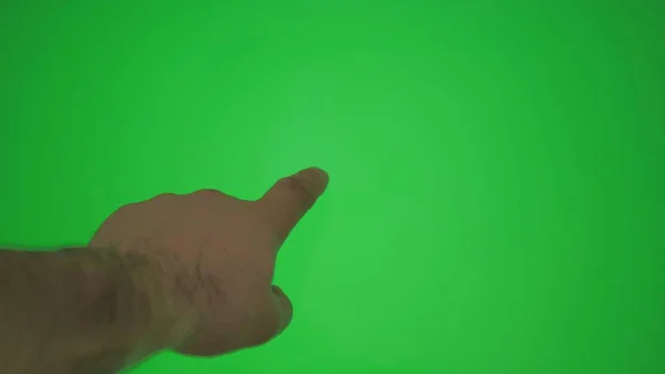 Male hand gestures on green screen: pointing or tapping on the screen, chromakey.