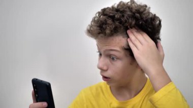 Problematic skin of a young man with curly hair. Pimples on the forehead. The problem of teenage acne and pimples on the skin of the face