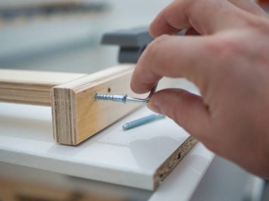 close-up of a man assembling furniture. close-up