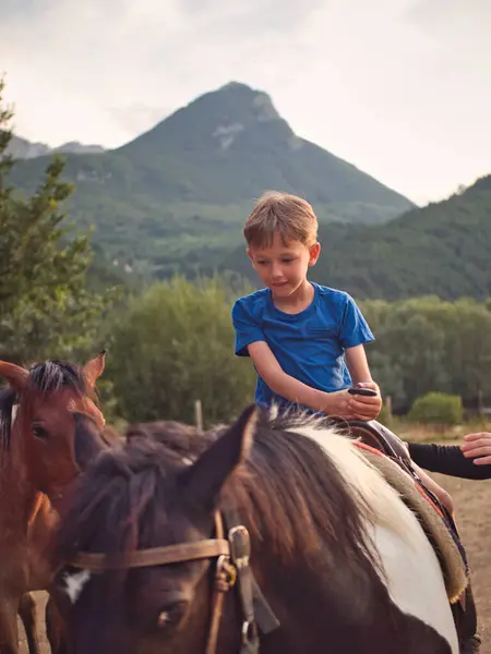 Children learn to ride horses by the river until sunset