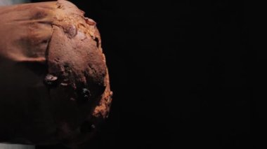 Pandora close-up, a typical Italian pastry, on a black background. vertical video.