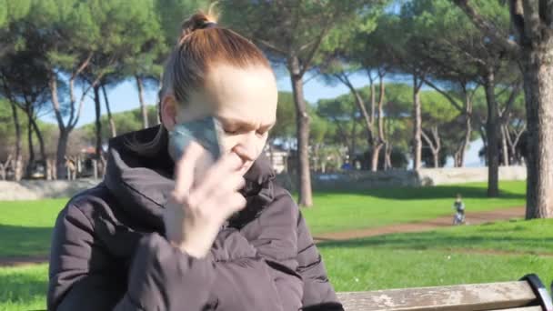 Young Mother Sitting Bench Talking Phone While Holding Stroller Her — Stok Video