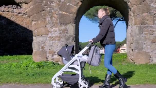 Young Mother Walks Stroller Park — Videoclip de stoc