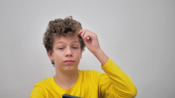 Portrait Young Man Curly Hair Squeezing Pimples While Looking Phone — Vídeo de stock
