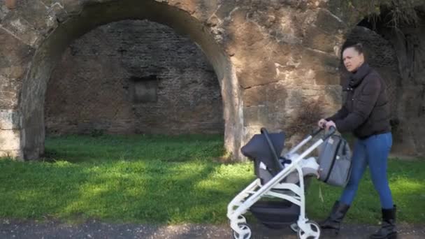 Young Mother Walks Park Stroller Slow — Stockvideo