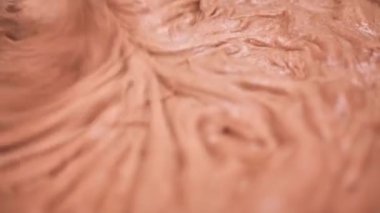 Process of making dough for pancakes with flour in paper bag on light table, eggs, flour beat with mixer. Pancake dough with ingredients beat mixer. Woman beats dough at kitchen table in kitchen