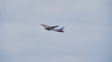 The plane takes off from the airport on the background of the sky, Transportation of passengers on vacation or travel