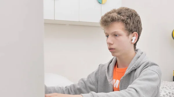 Child Uses Laptop Desk Boy Curly Hair Wearing Headphones Listening — Stock Photo, Image