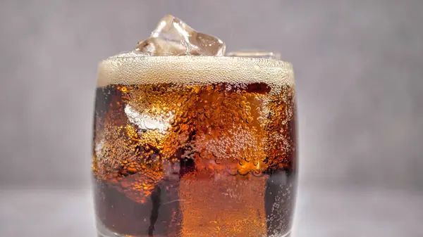 soda in a glass with ice. close-up
