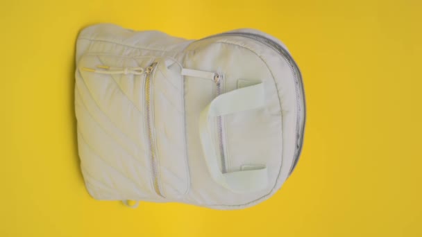 Green Backpack Yellow Background Vertical Video — Stock Video