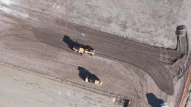 Construction industrial machinery excavator tractor sand pit aerial drone view shot top angle.