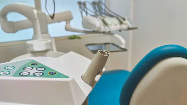 Modern dental office. Dental chair and other accessories used by dentists in blue, medical light.